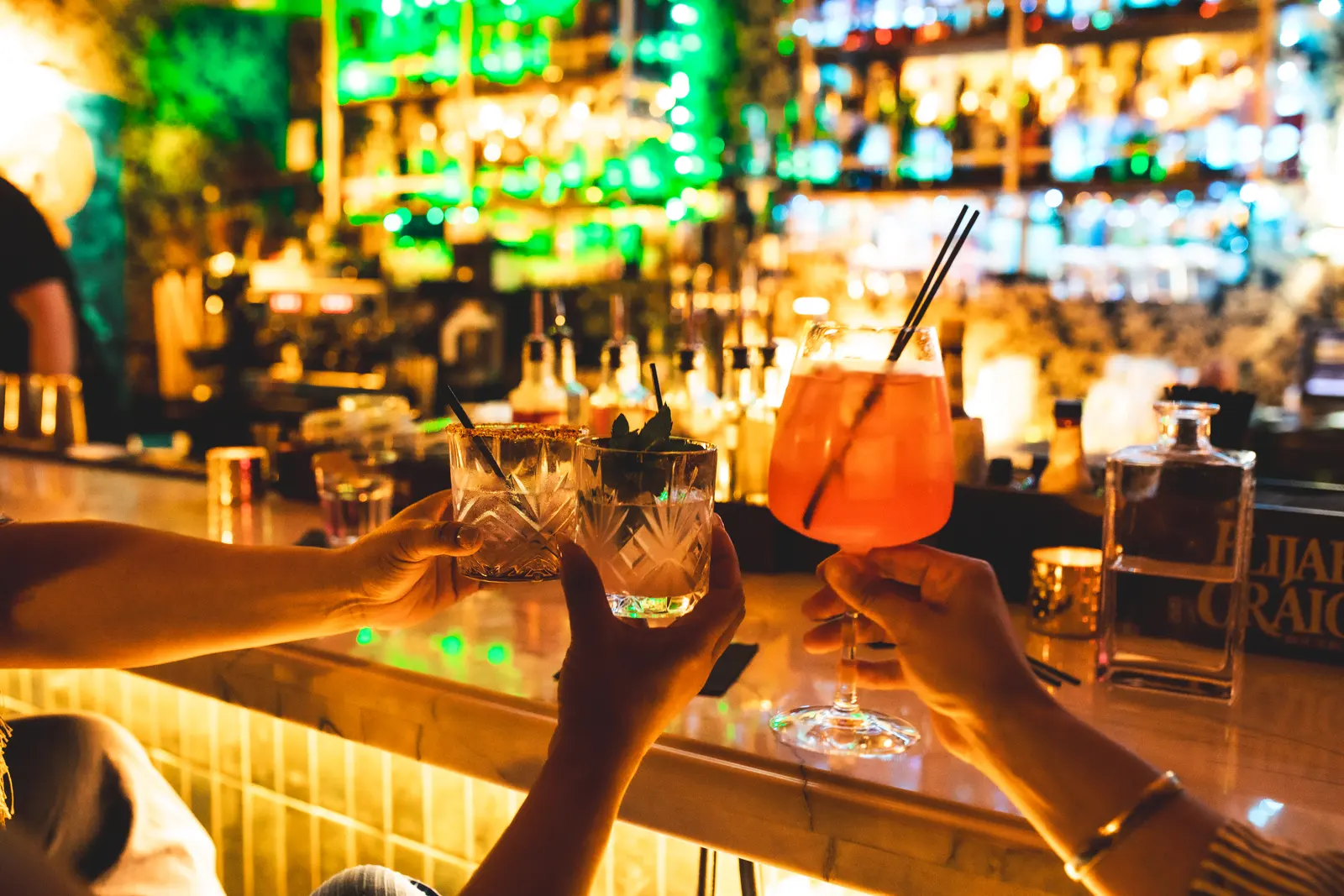 Guests toasting cocktails at the ASA bar